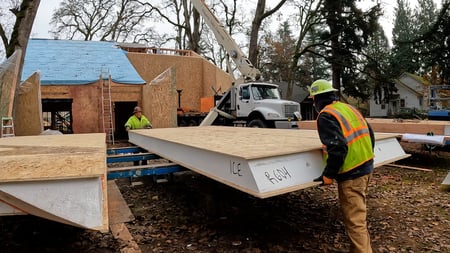 Structural Insulated Panels being installed on a jobsite to support consistent, airtight building envelope performance.